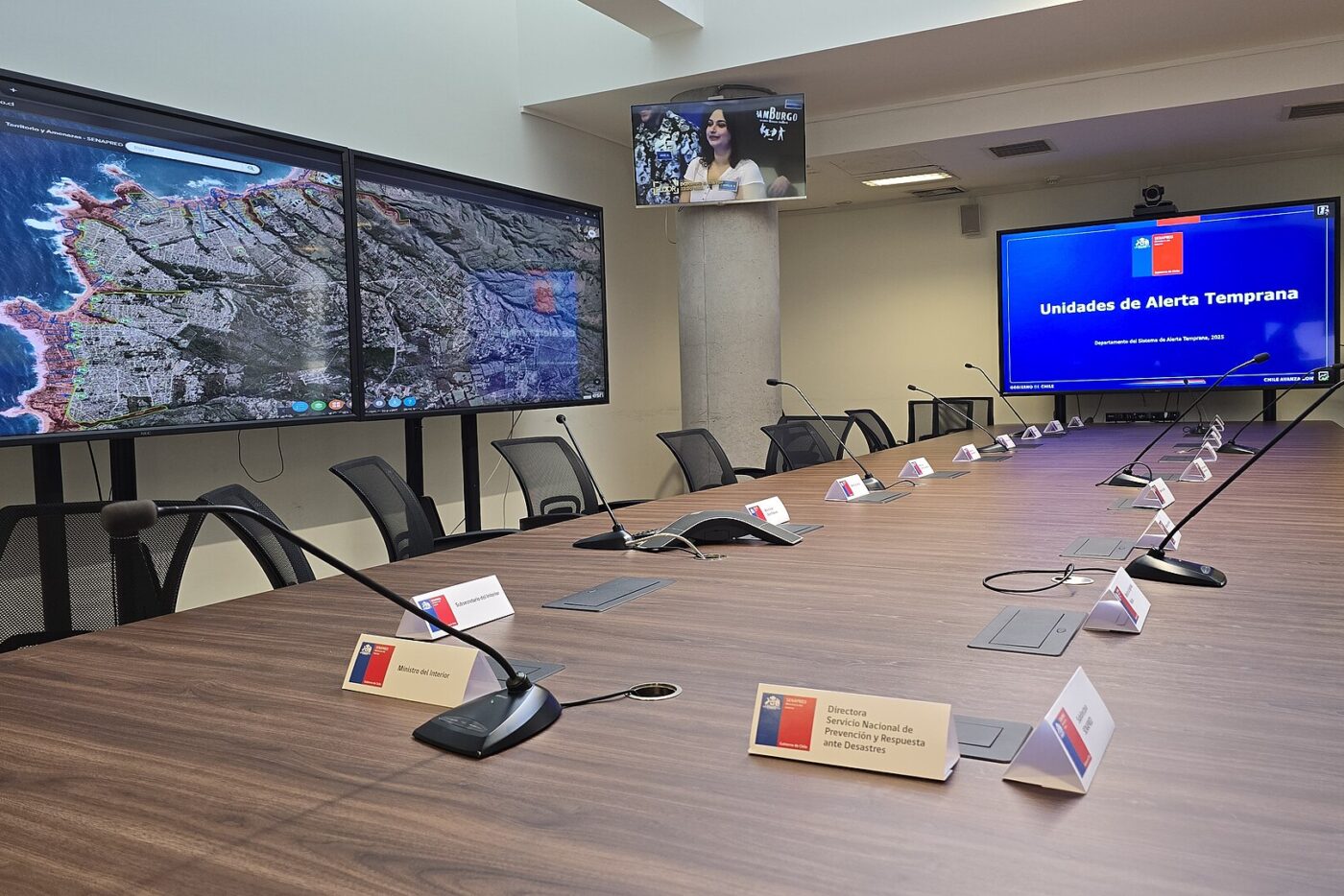 Sala de coordinación de emergencias de Senapred, con pantallas y una mesa larga