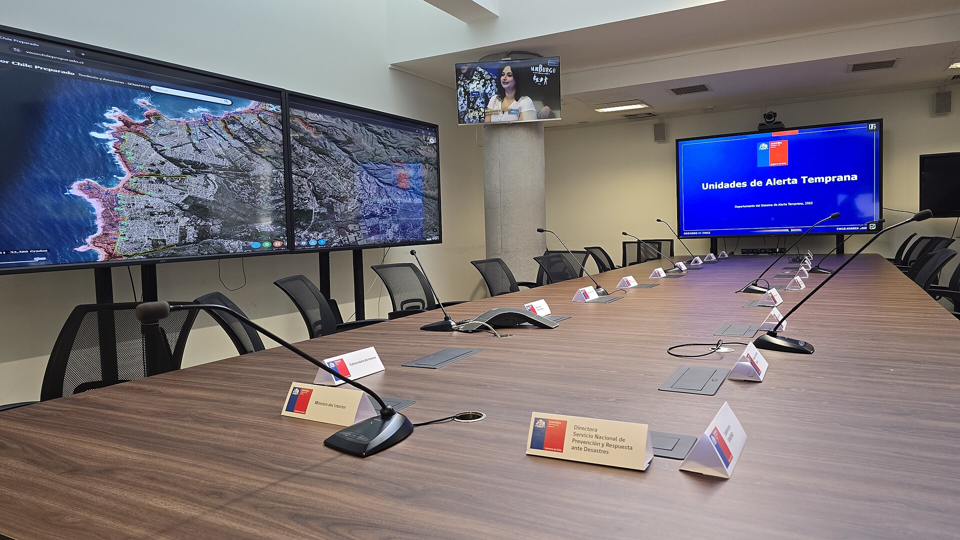 Sala de coordinación de emergencias de Senapred, con pantallas y una mesa larga